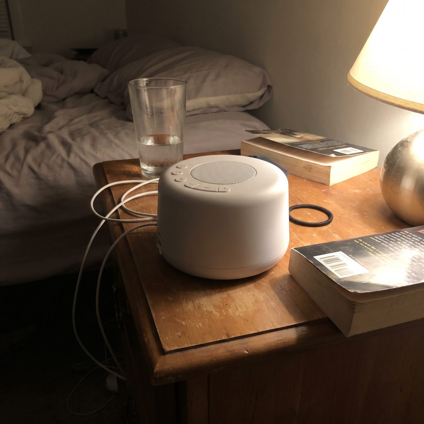 An ordinary sound machine on a nightstand at night